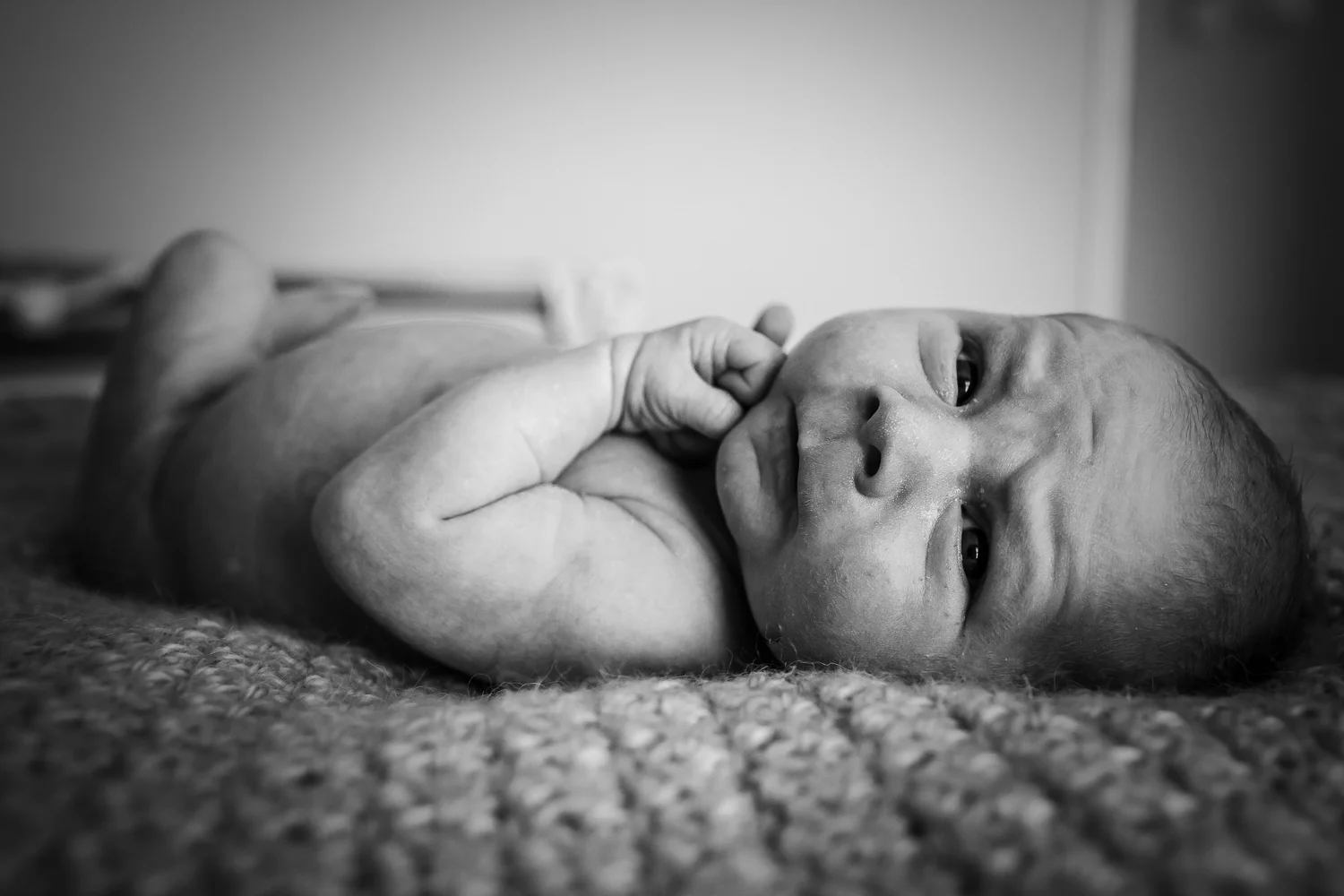 Serious face newborn details during in home lifestyle session