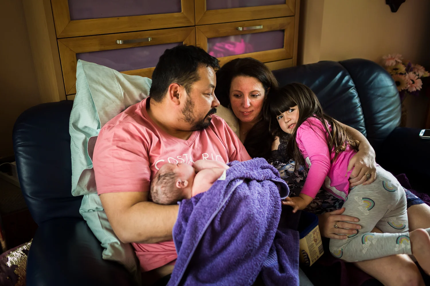 family enjoying some quiet moments after the birth of their newest member at home birth in Melbourne Victoria. Captured by A Grateful Heart Photography