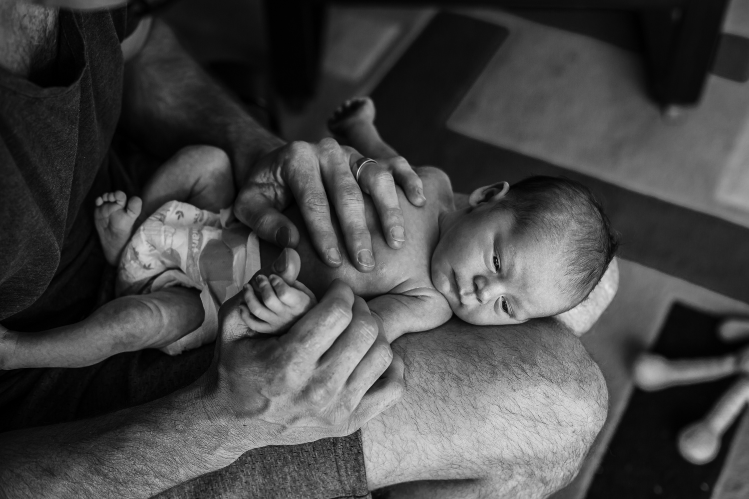 father holding newborn son during in home lifestlye photography session at home in Mornington Peninsula