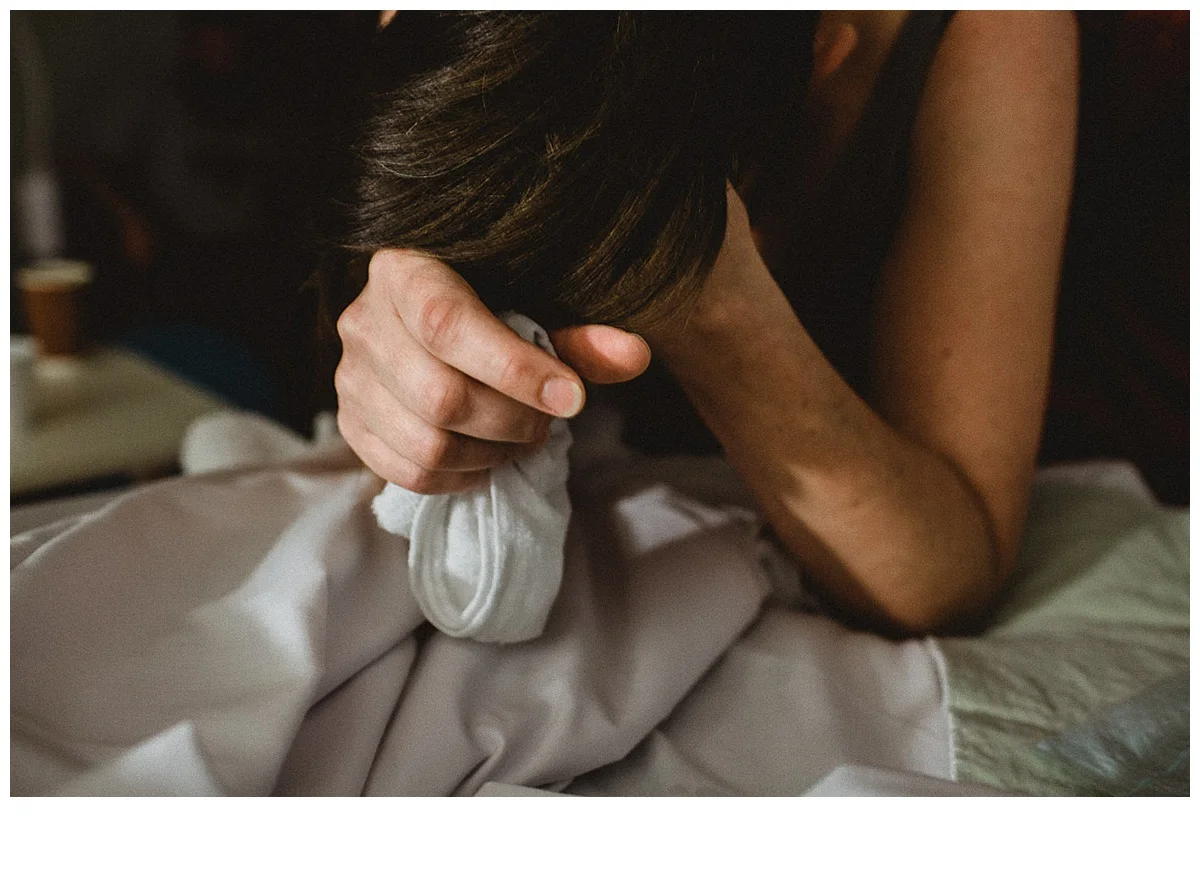 Mother concentrating on surges holding a tissue as she transitions at Casey Hospital in Berwick
