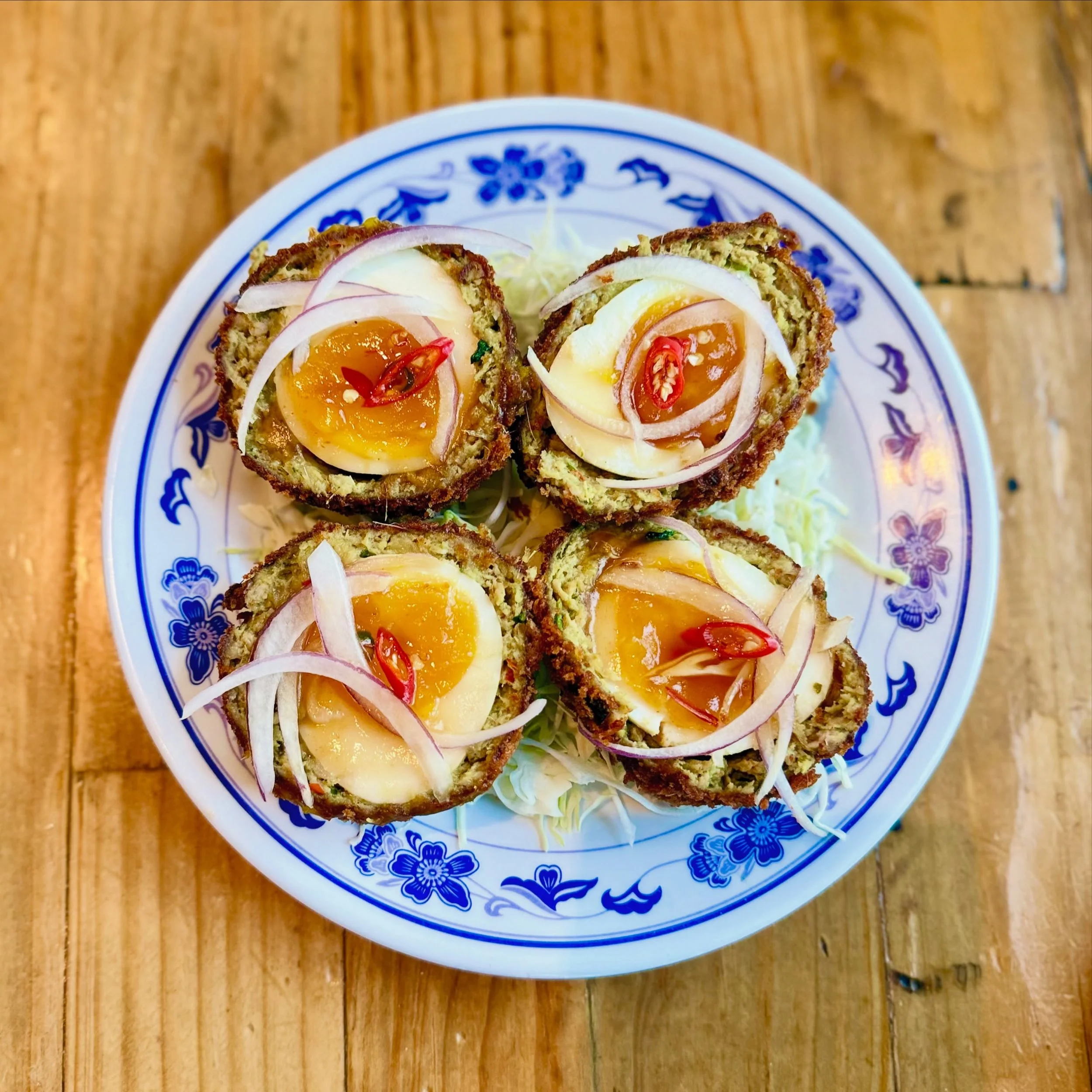 Our new SON IN LAW SCOTCH EGG is a mashup between two of our favorite egg dishes from Thailand &amp; Scotland. Jammy eggs covered in our house Thai herb sausage, breaded in panko &amp; fried, split in half &amp; served with a tamarind-fish sauce &amp