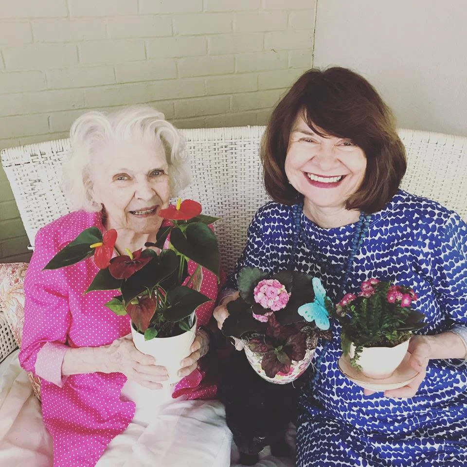 My mom and my grandmother with their flowers and teacups. I love that color blue that my mom is wearing. Come to think of it, they're both sort of dressed like flowers.