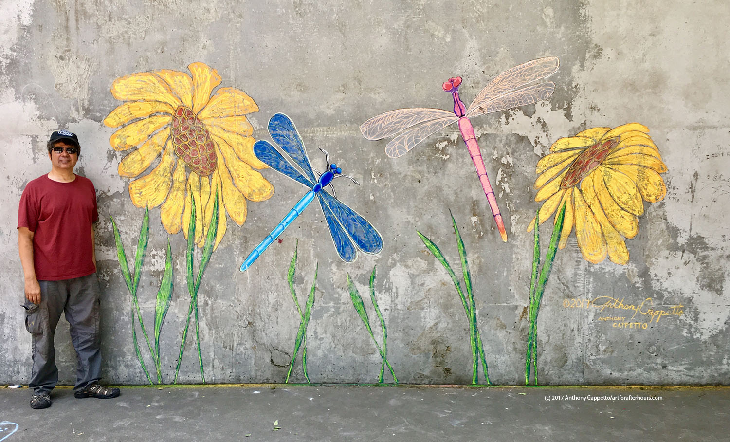 Anthony Cappetto of Art for After Hours with the project 'Dragon Flies and Sunflowers', a street art installation as part of Community Field Day in Battery Park in New York City. July 2017. 