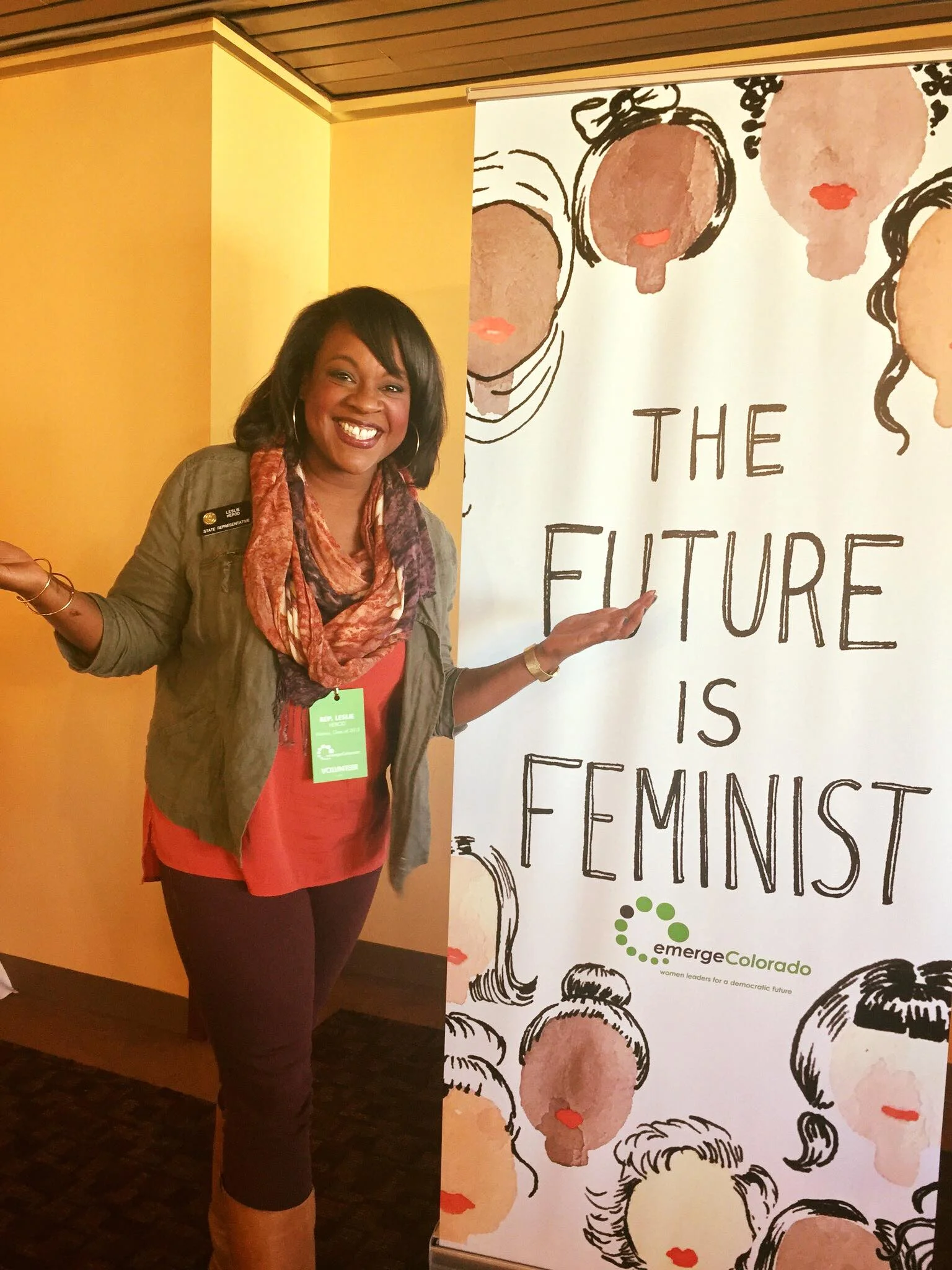 Herod, at an Emerge Colorado event, next to the art of Kimothy Joy. Photo from social media. 