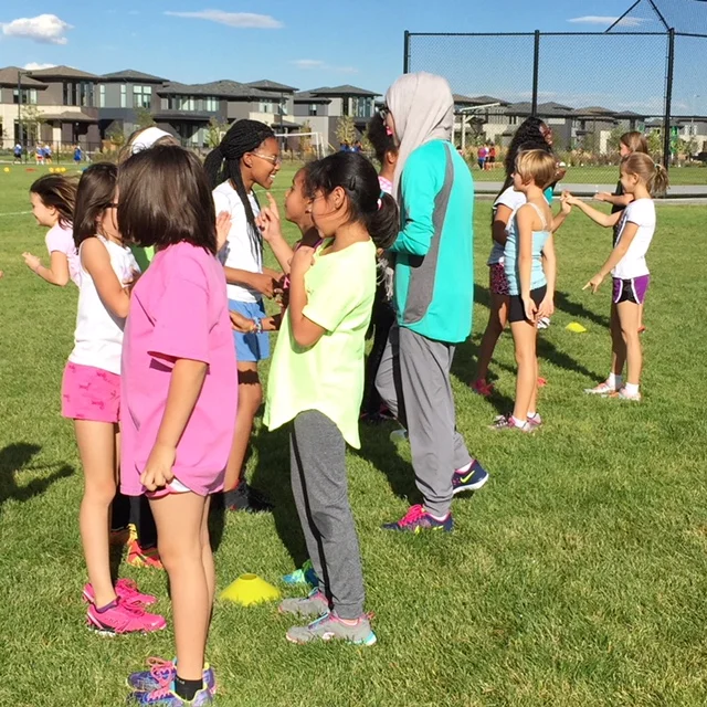 Girls on the Run building connections with their teammates during a workout at practice. Cover image: High Tech Elementary Girls on the Run participants about to cross the finish line in their 2017 5k. PC: Lisa Ordway, Girls on the Run and Bri Miller. 