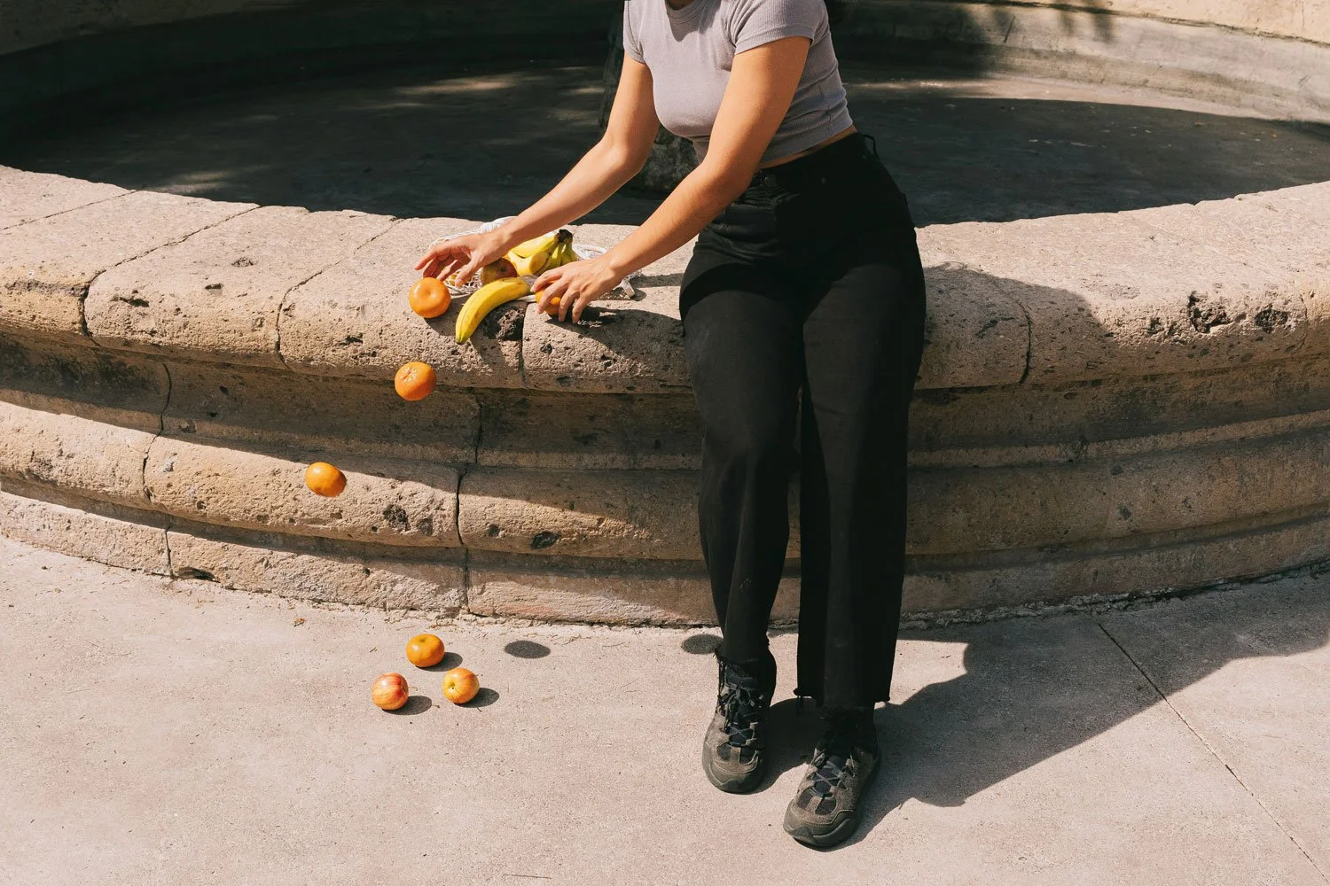 woman dropping fruit onto the ground by accident symbolizing making a mistake with your branding and website marketing