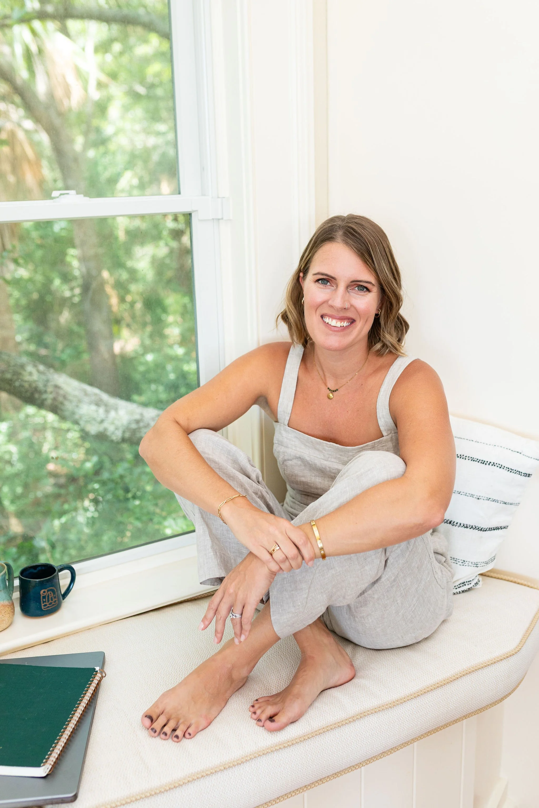 Callie Cullum, founder of The Look & The Feel, sitting in a sunny window seat
