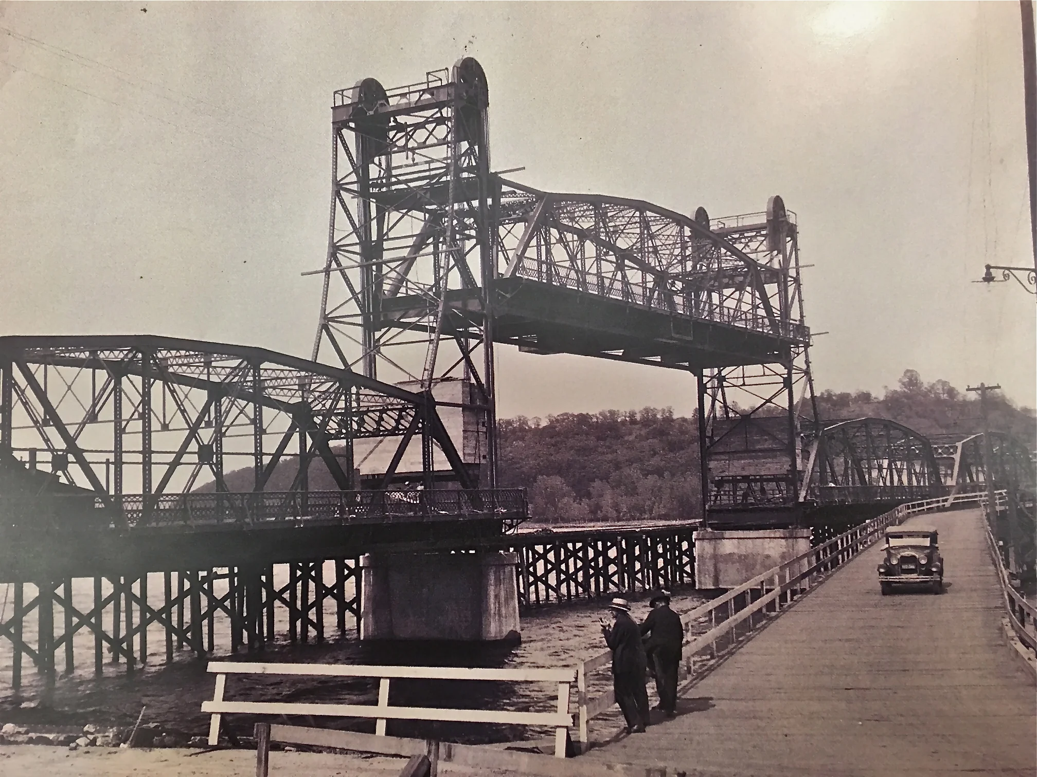 Lift Bridge Under Construction While Pontoon Bridge Was In Use. The Year was 1931. Photo credit, Mr. John Runk, courtesy of the Stillwater Public Library. To travel through the "Time Tunnel" from 1875 to 1931, Click or Tap the photo above . Imagine yourself walking across the old wooden bridge onto the new lift bridge from 1875 to 1931 !