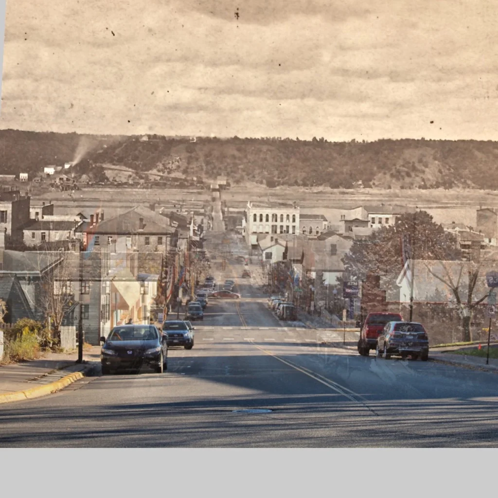This is a "Time Tunnel" photo that takes you from 2016 to ca.1875. The historic photo is from the John Runk Collection,the 2016 photo is credited to T.Wieland and R.Molenda.