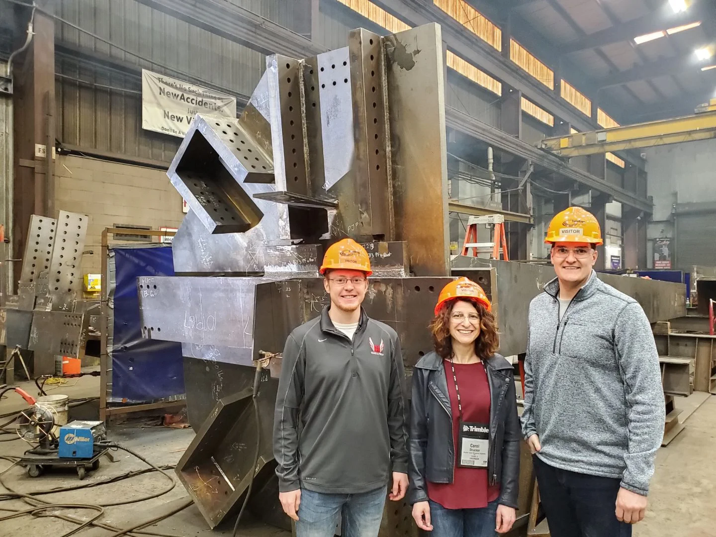 Logan Bertling, Carol Drucker, Michael Herriges visit the shop where the outrigger and belt trusses are being fabricated for the 110 N Wacker project in Chicago. The connections are designed by DZSE.