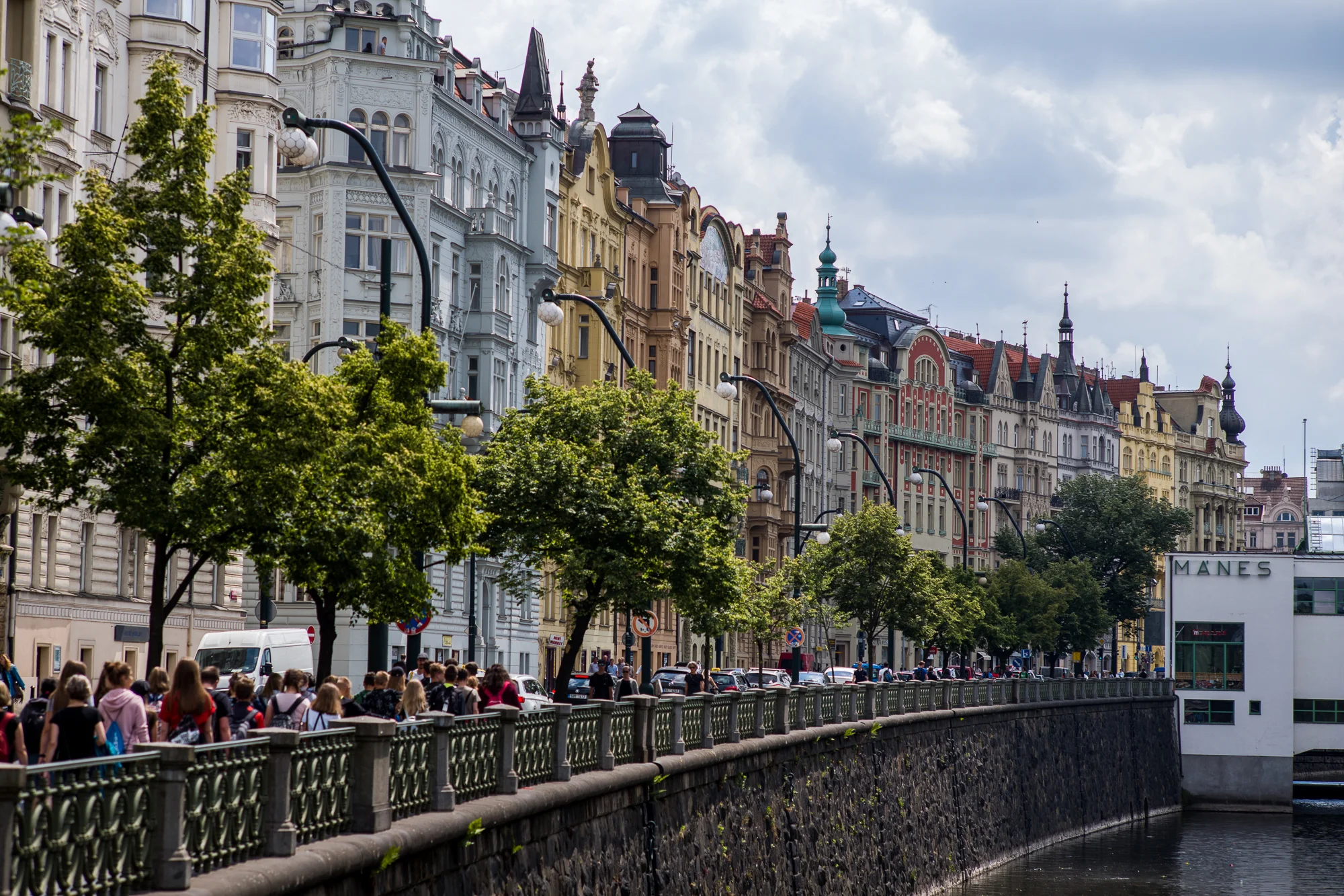 Buildings and people next to the Vltava River