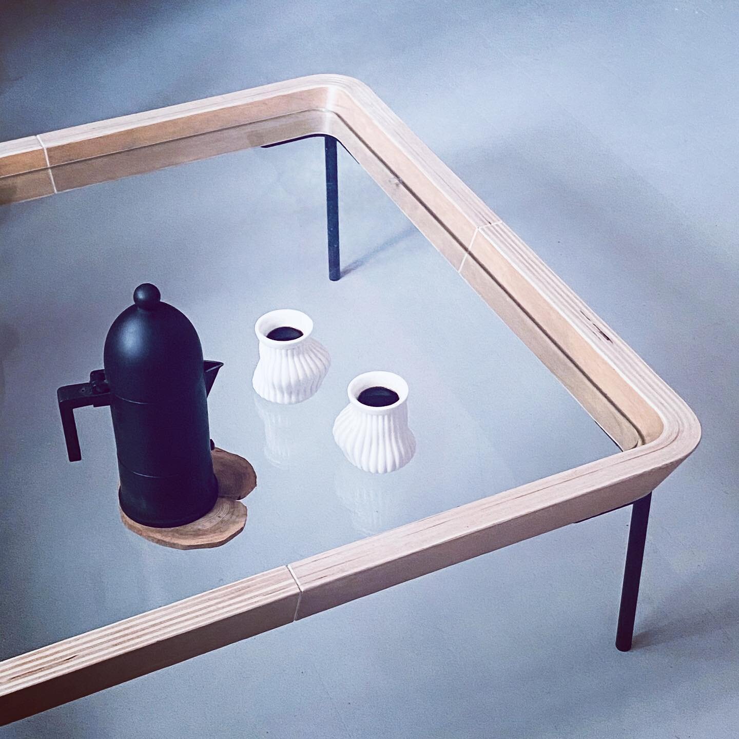 JP glass top table accompanied with Alessi La Cupola by Aldo Rossi and Supple Cups by Greg Lynn. The birch plywood furniture frame pressed at Piiroinen. Frame components cut and joined by the designer. 
.
.
.
#jessexpietilaxstudio 
#alessi 
#aldoross