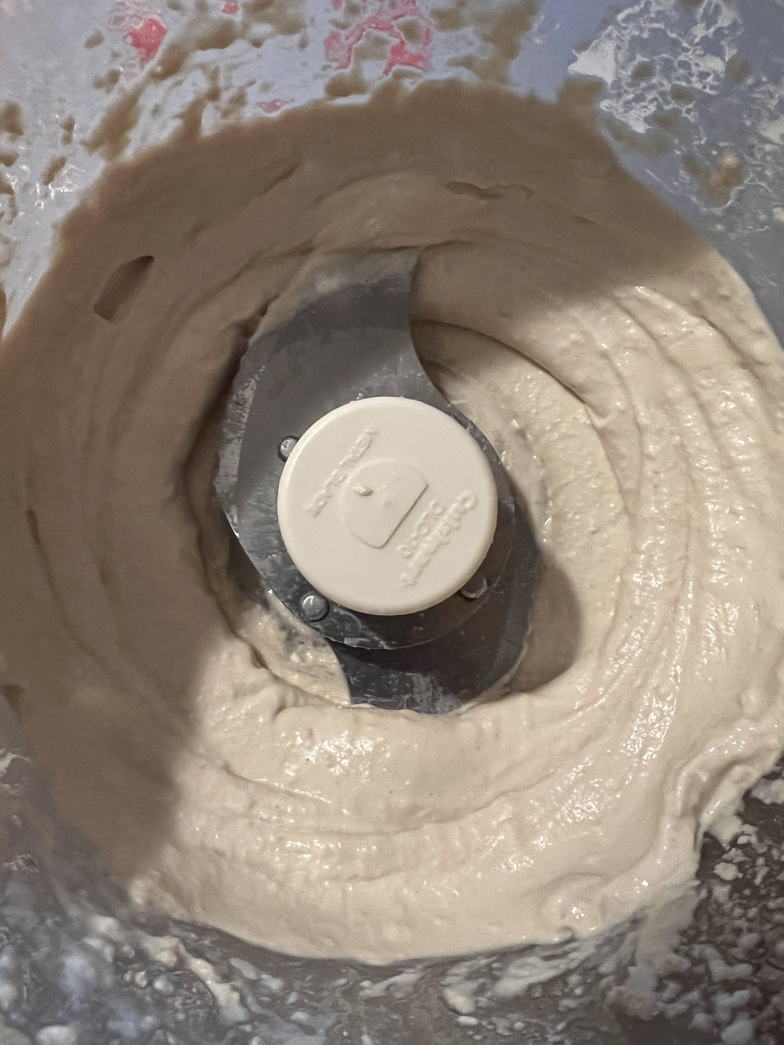 Tahini mixture is light, creamy, and almost fluffy after adding the ice cube.