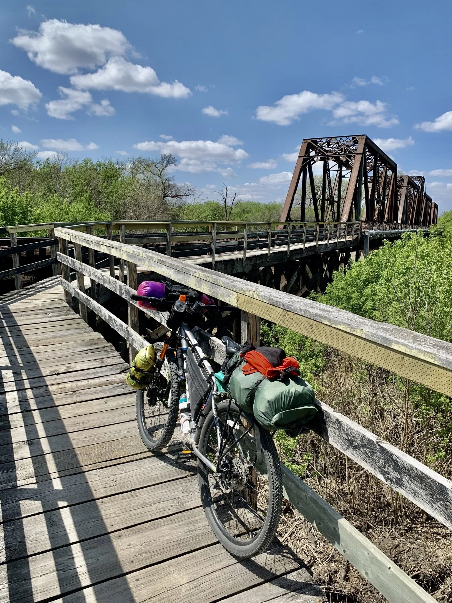 Crossing the Red River on the side of the rail bridge