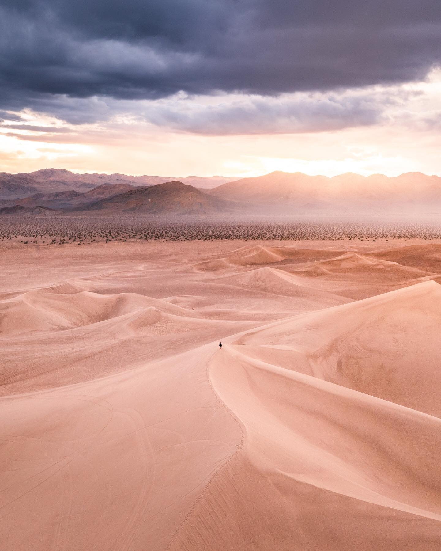 Feeling small amongst the dunes.
It was at this moment that I started feeling sprinkles and brought my drone down before running down the dune in what turned into pouring rain. 
I ended up soaked by the time I made it back to the trailer, but standin