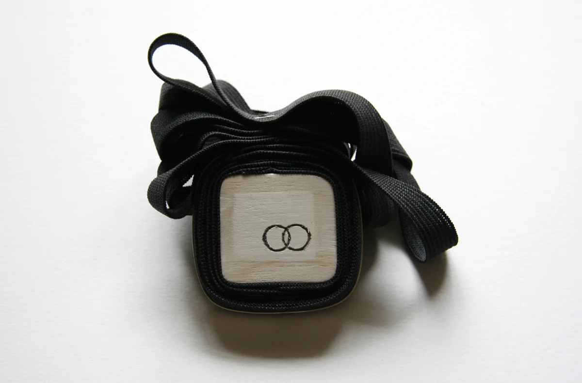 Wrapped, brooch. silver, wood, elastic, 2.5”x3” 