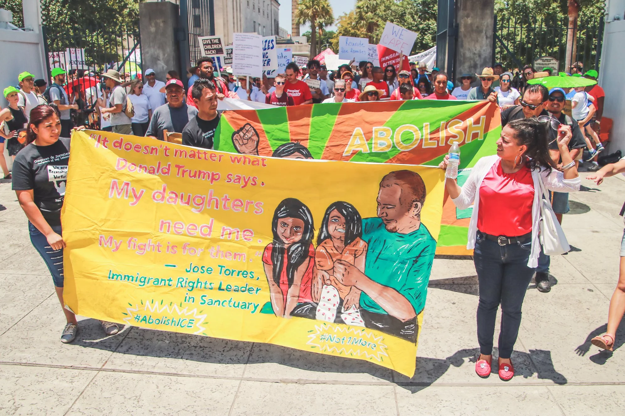 Collaborative banner work featuring local immigrant rights leader Jose Torres . Photo by Fernando Lopez .