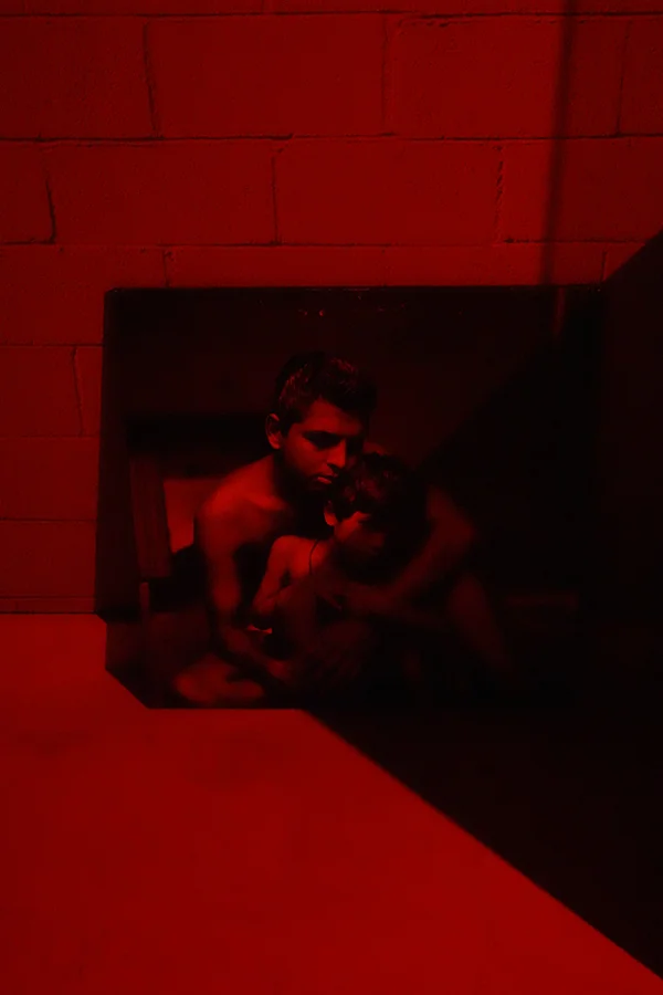 Portrait of a young Ramesh and his son, Neel, in a corner of the darkroom