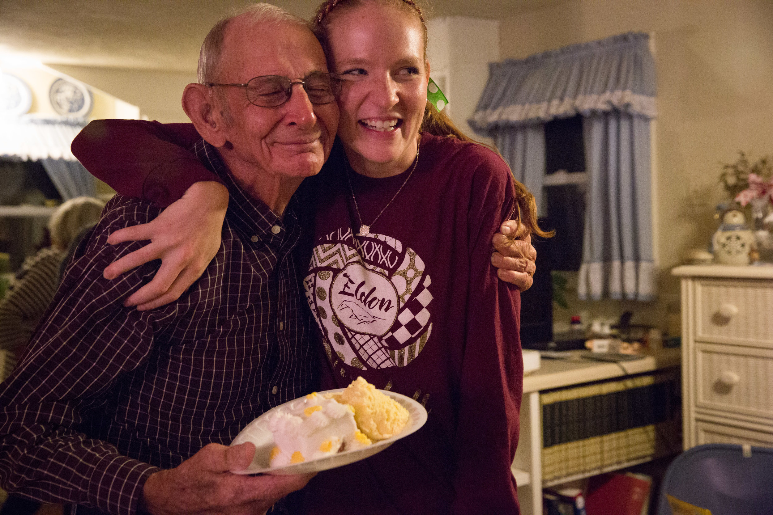 Carl hugs granddaughter Andrea on his 85th Birthday. He doesn't like to make a fuss, but agreed to let the family bring cake and ice cream to his house for an intimate celebration. 