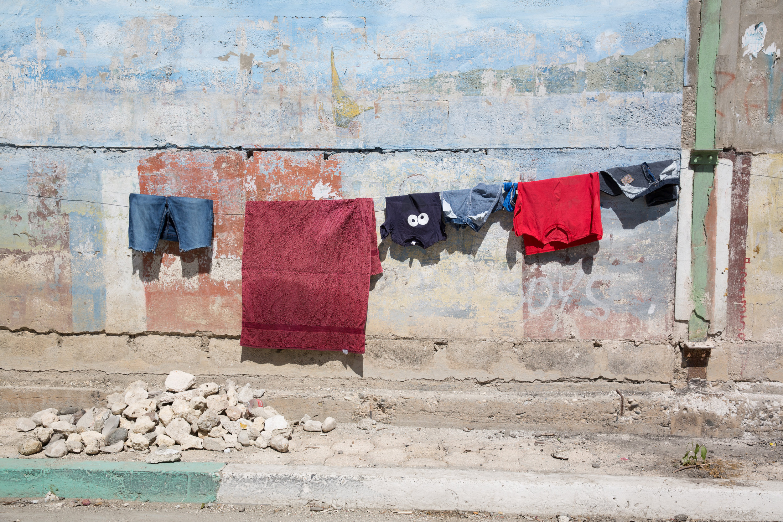 Laundry hangs along Rue Du Commerce in Jacmel, Haiti, on Feb. 4, 2018. Without washing machines, washing clothes by hand at the river or at home is a regular chore for many Haitian women and girls. 