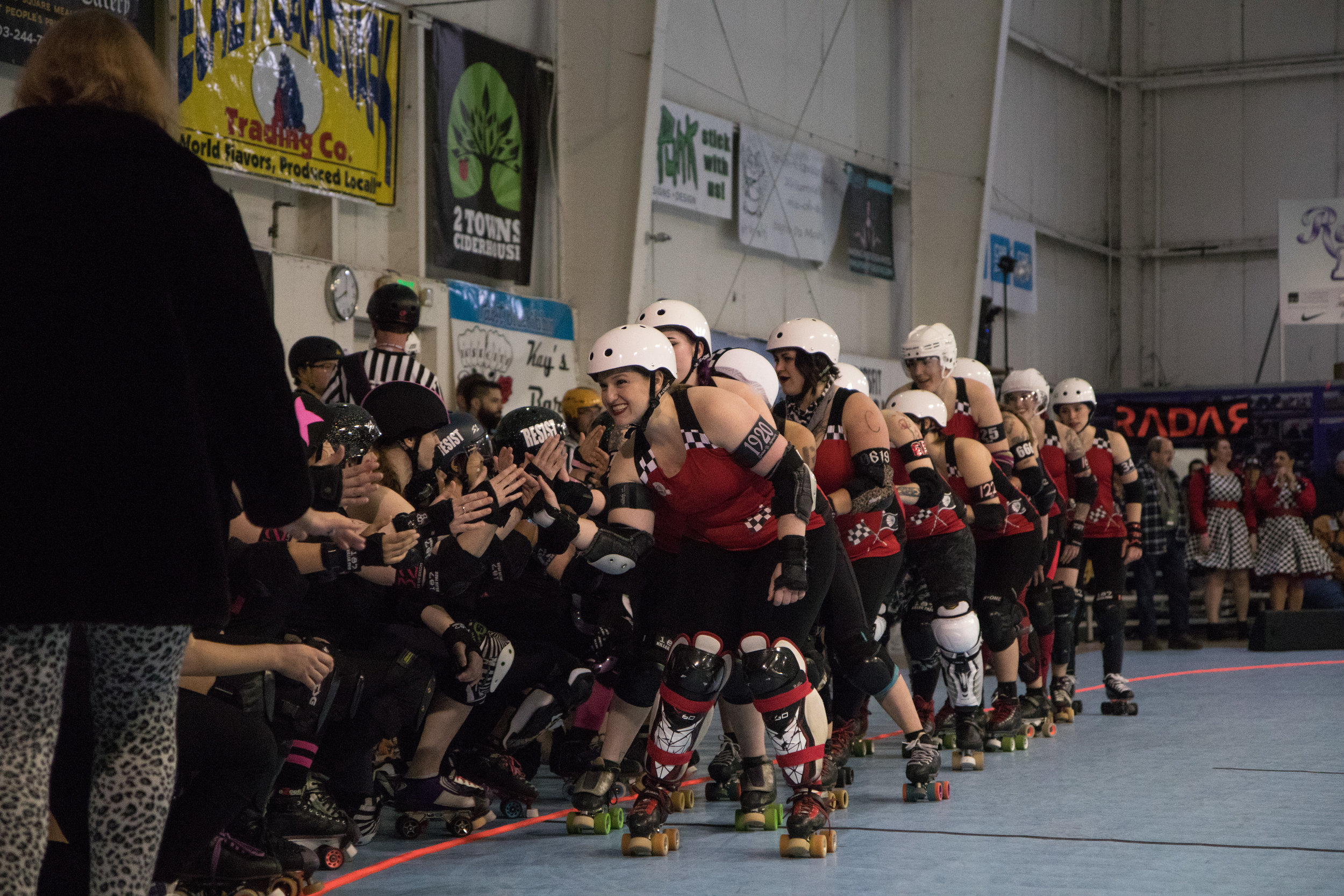 Susan B. Animosity (front) and the Betties shake hands with opponents Guns N Roses. Though they are intense rivals on the track, many have close friendships with players from teams across the league. Break Neck Betties hold the league record for the most championship wins in Rose City Rollers history.