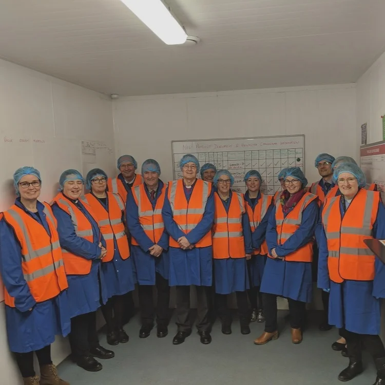 The group kitted out for a tour around the factory