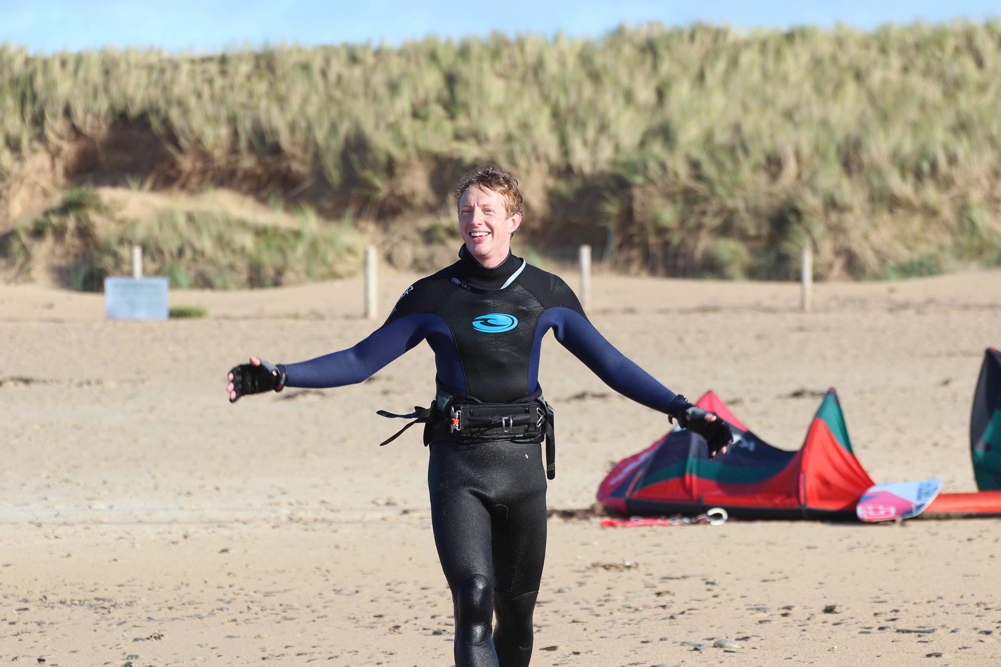 kitesurfer walking beach.jpg
