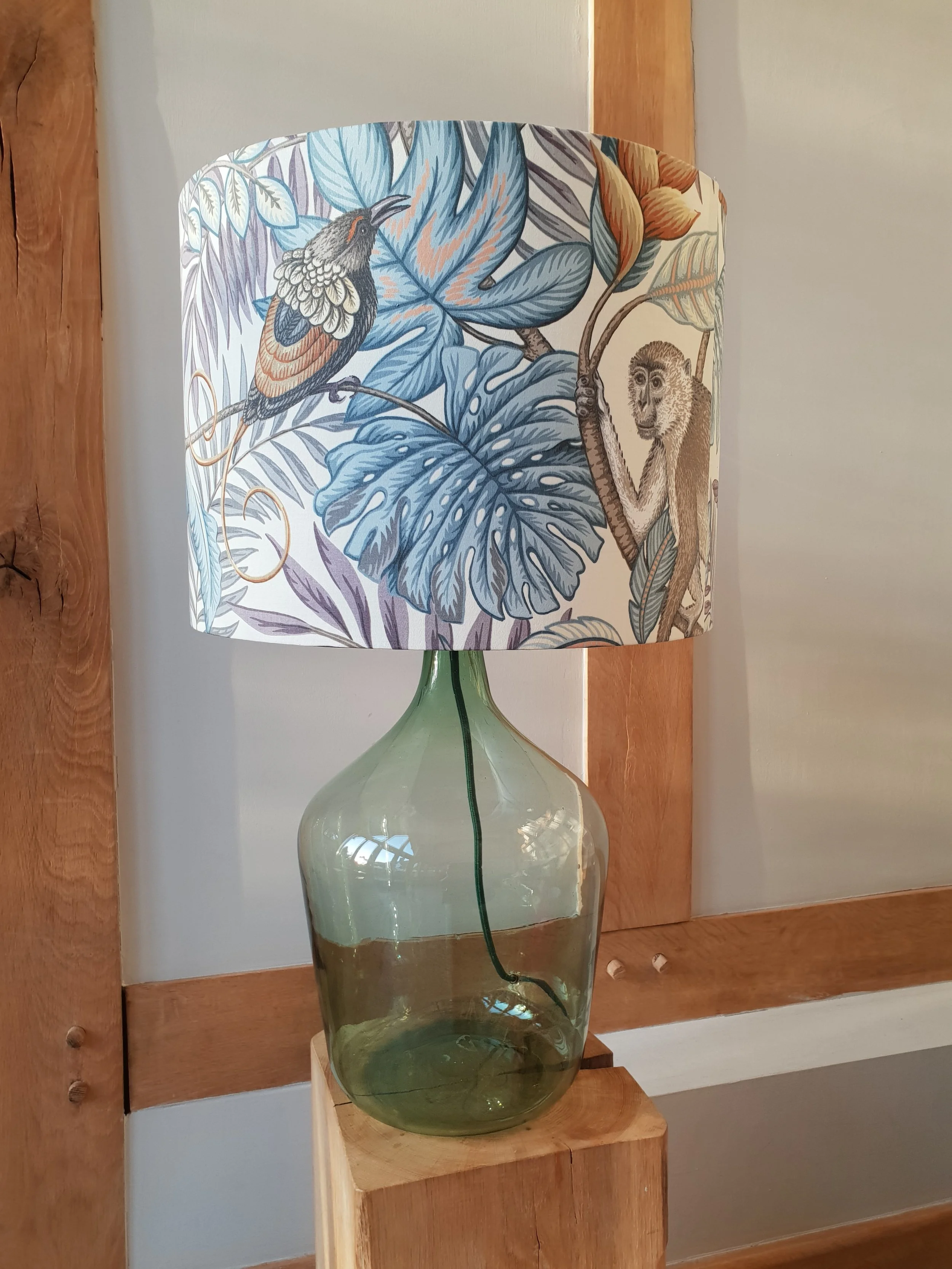 Natural Glass Carbouy with blue Jungle print shade.jpg
