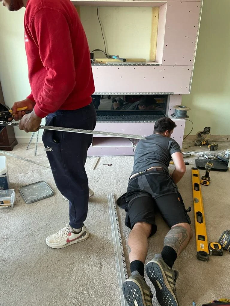 This is Karl trying to fit lights around our new chimney breast !! 