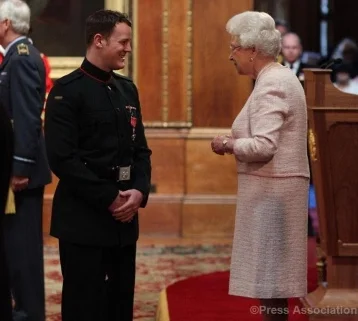 Michael Swain being awarded an MBE from Her Majesty the Queen.