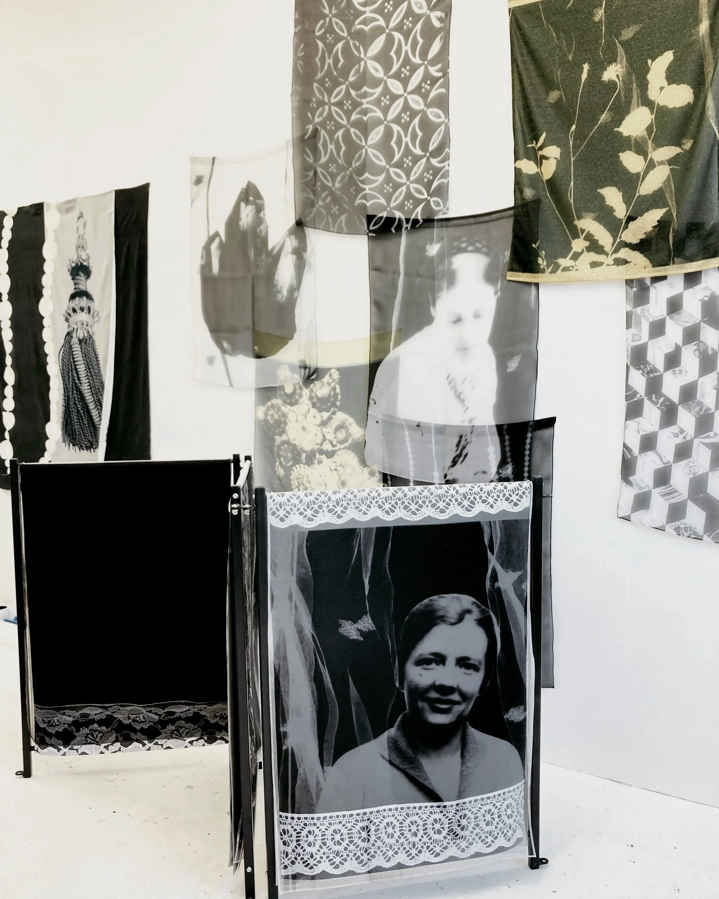 Printed fabrics installation, Portrait of Head Cook Dora Lee in foreground,  2023