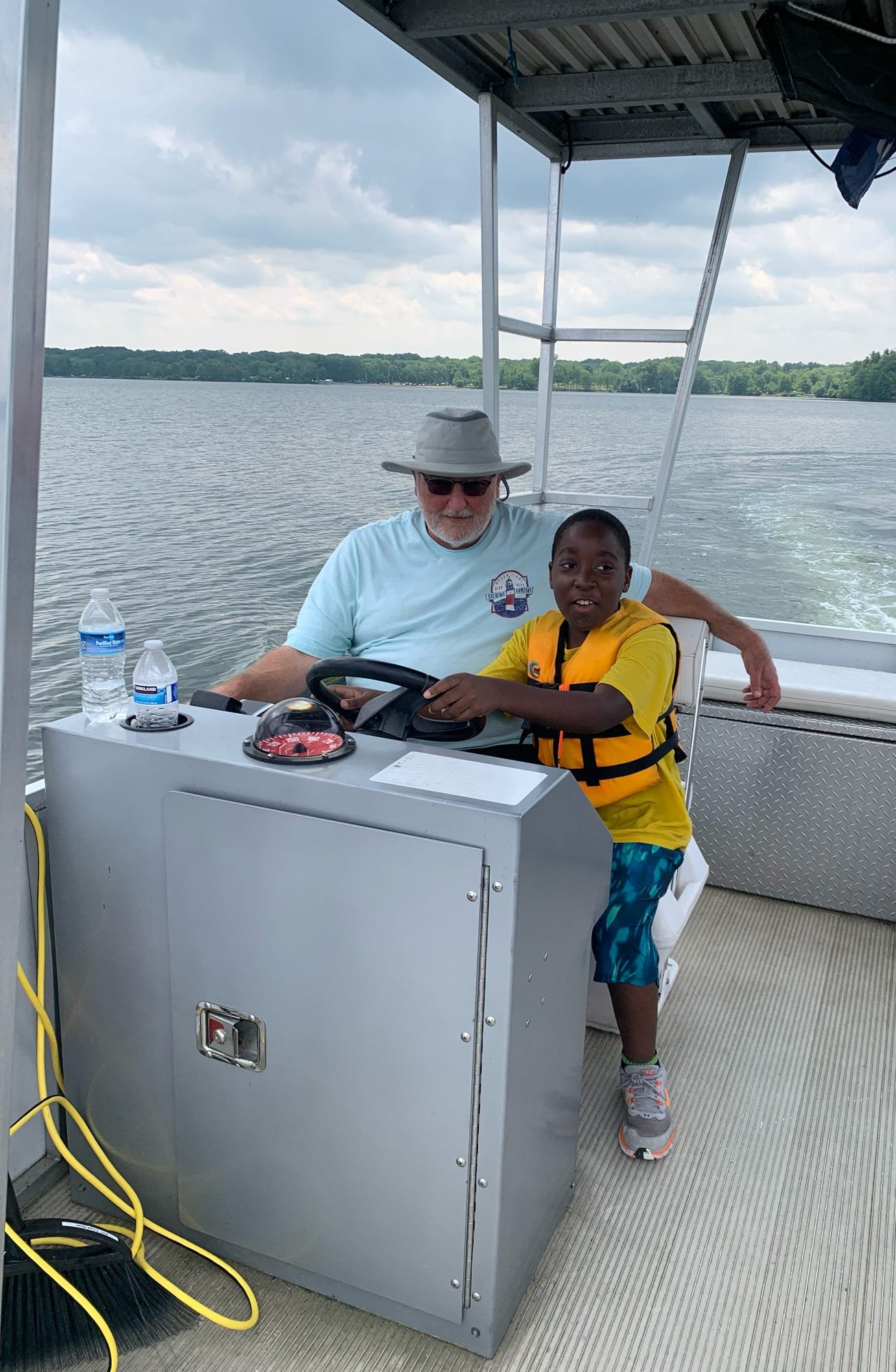 Envision athlete gets a chance to steer the boat at camp 