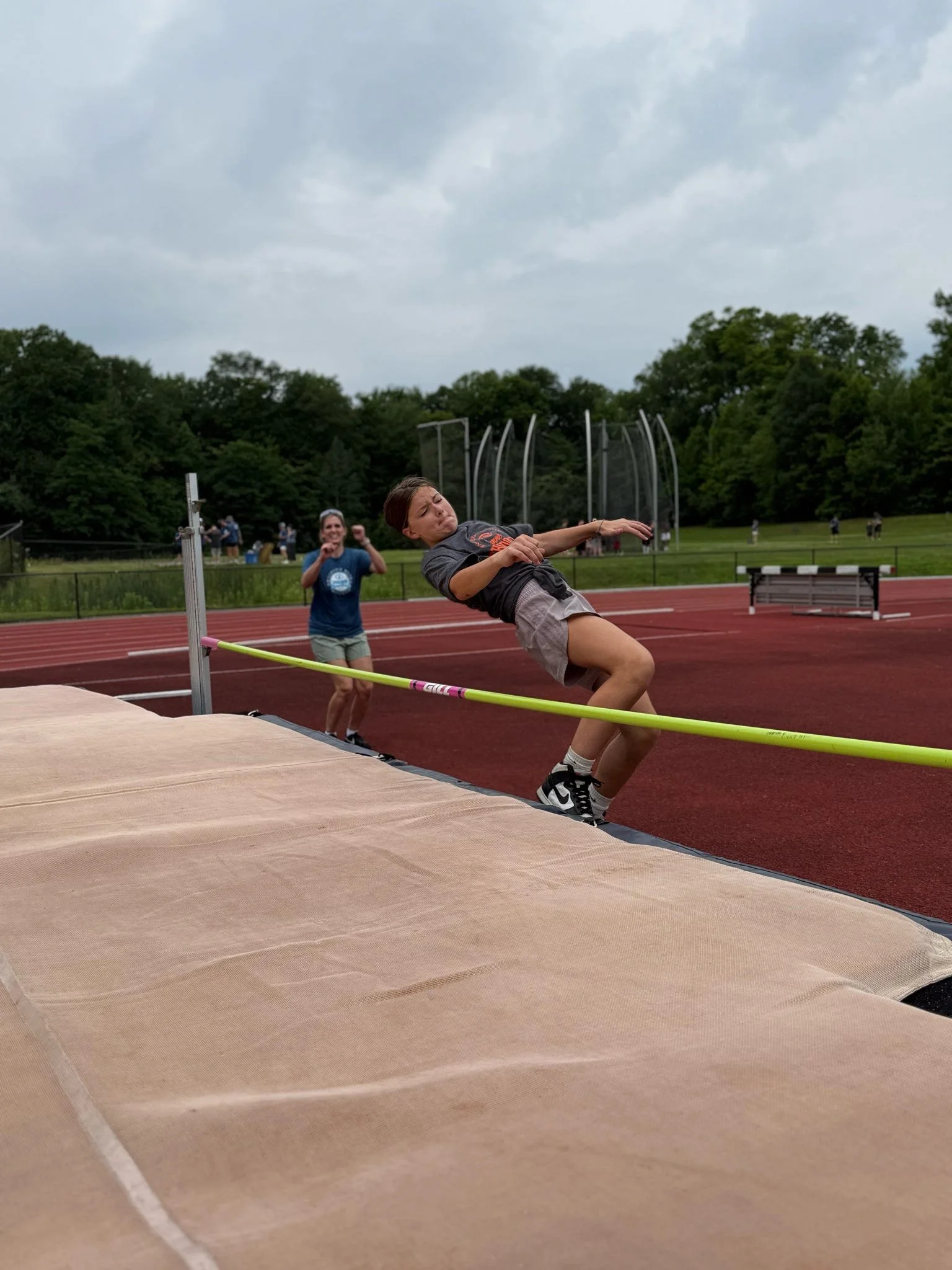 Athlete jumping over high bar as she competes in the high jump competition