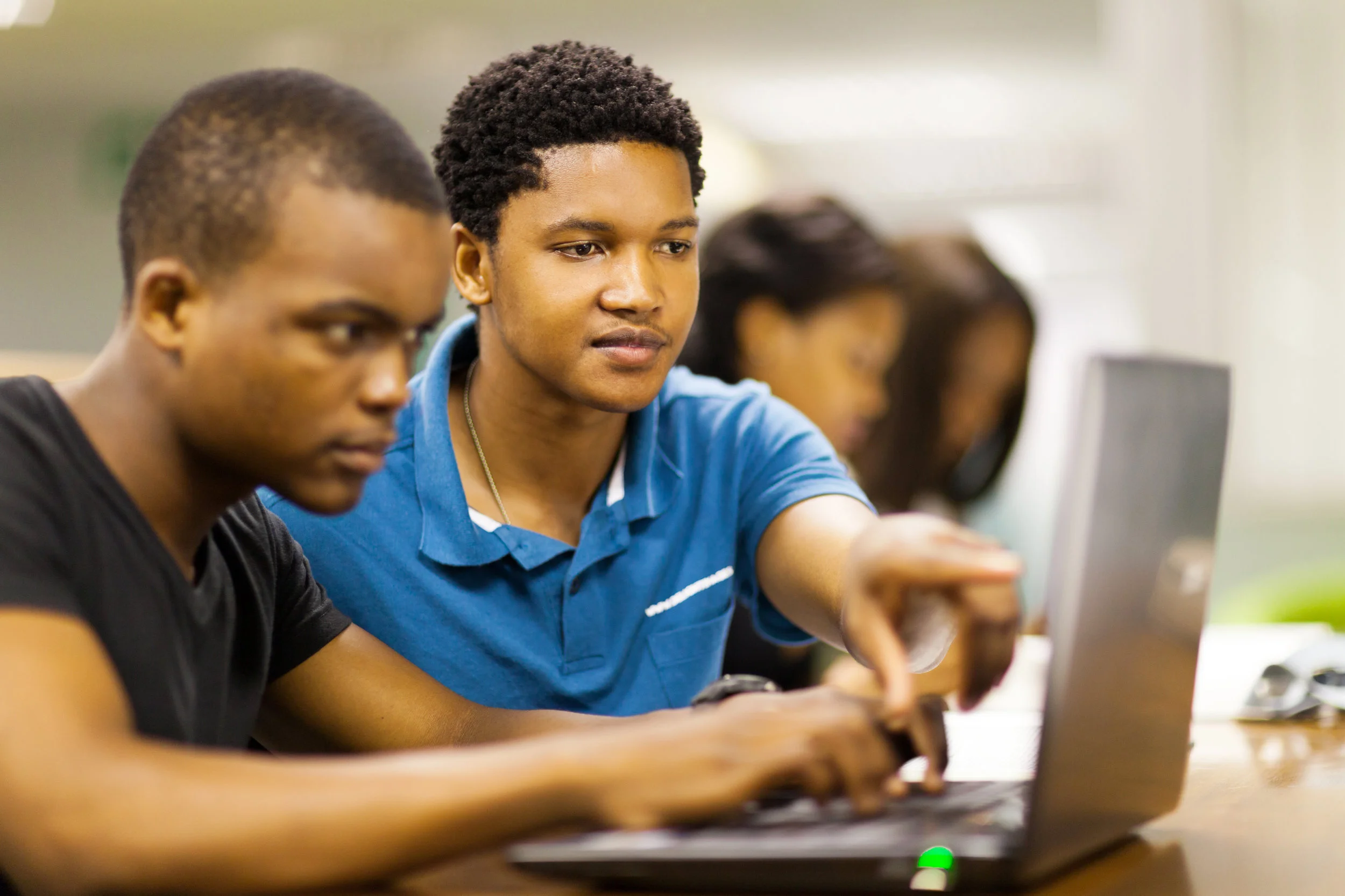 stock-photo-african-college-students-using-laptop-together-126952187.jpg