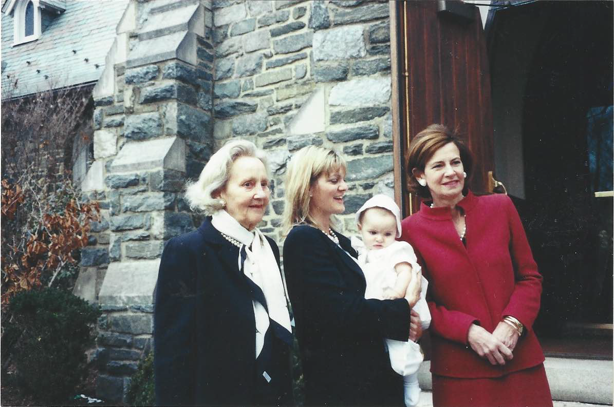 Katharine Weymouth (center), with her grandmother Katharine Graham (left), daughter (in Weymouth’s arms), and her mother Lally Weymouth (right) at the National Cathedral.