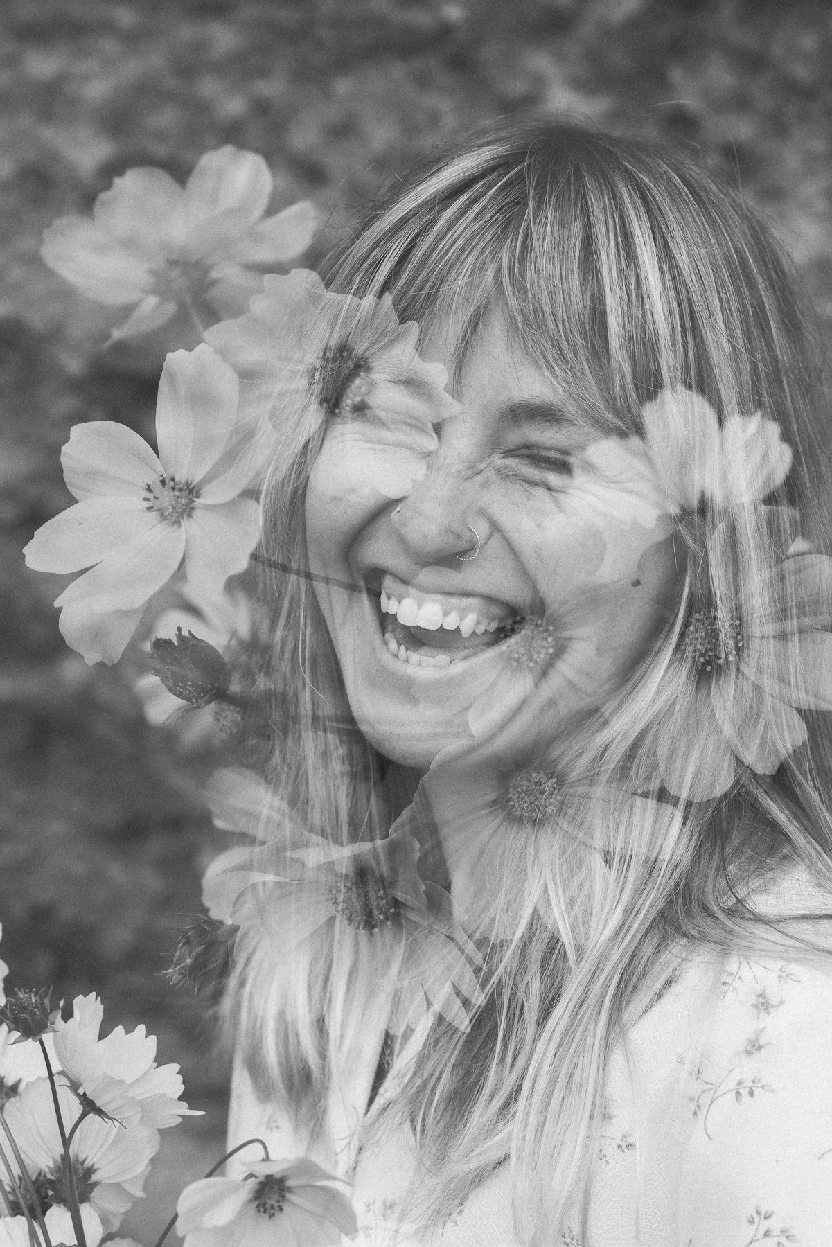 A double exposure photograph combining a smiling woman with headphones and flowers, creating a layered, artistic effect.