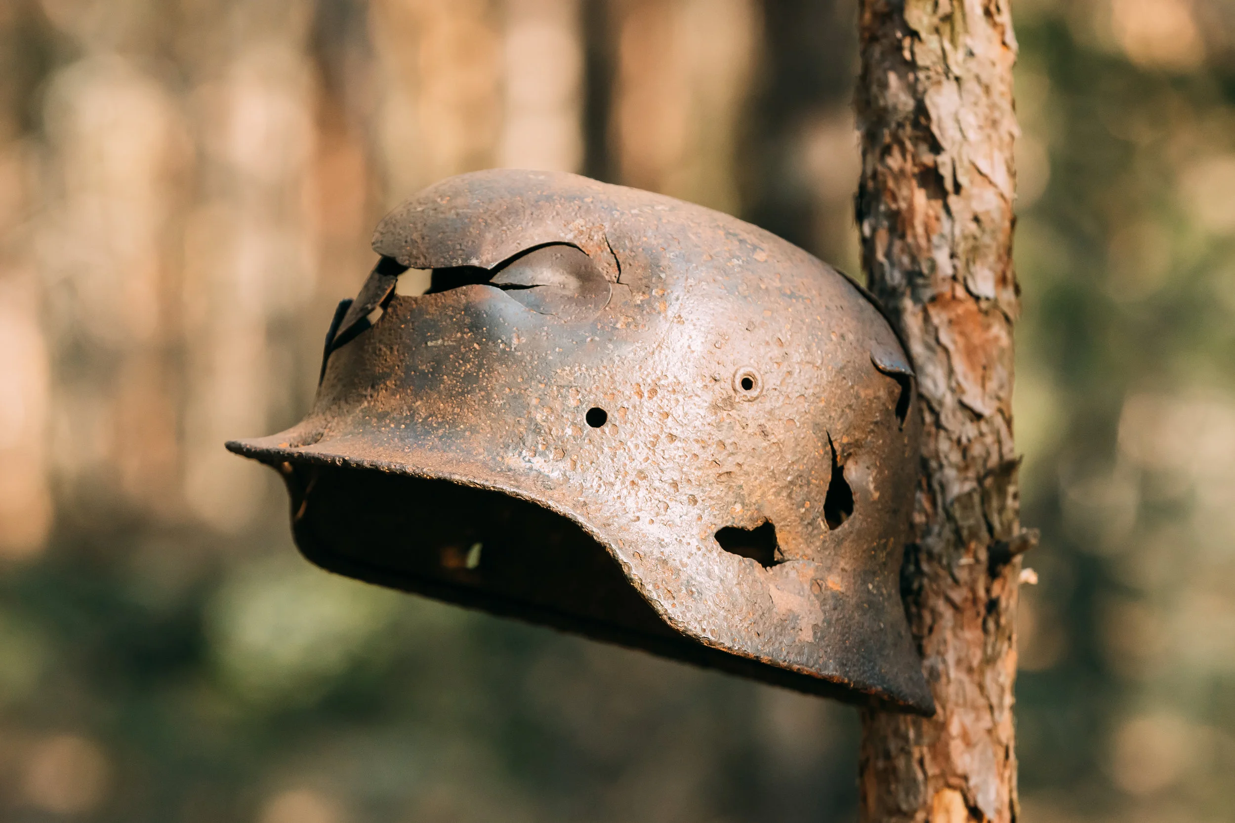 damaged-by-bullets-and-shrapnel-metal-helmet-of-PBJAV7H.jpg