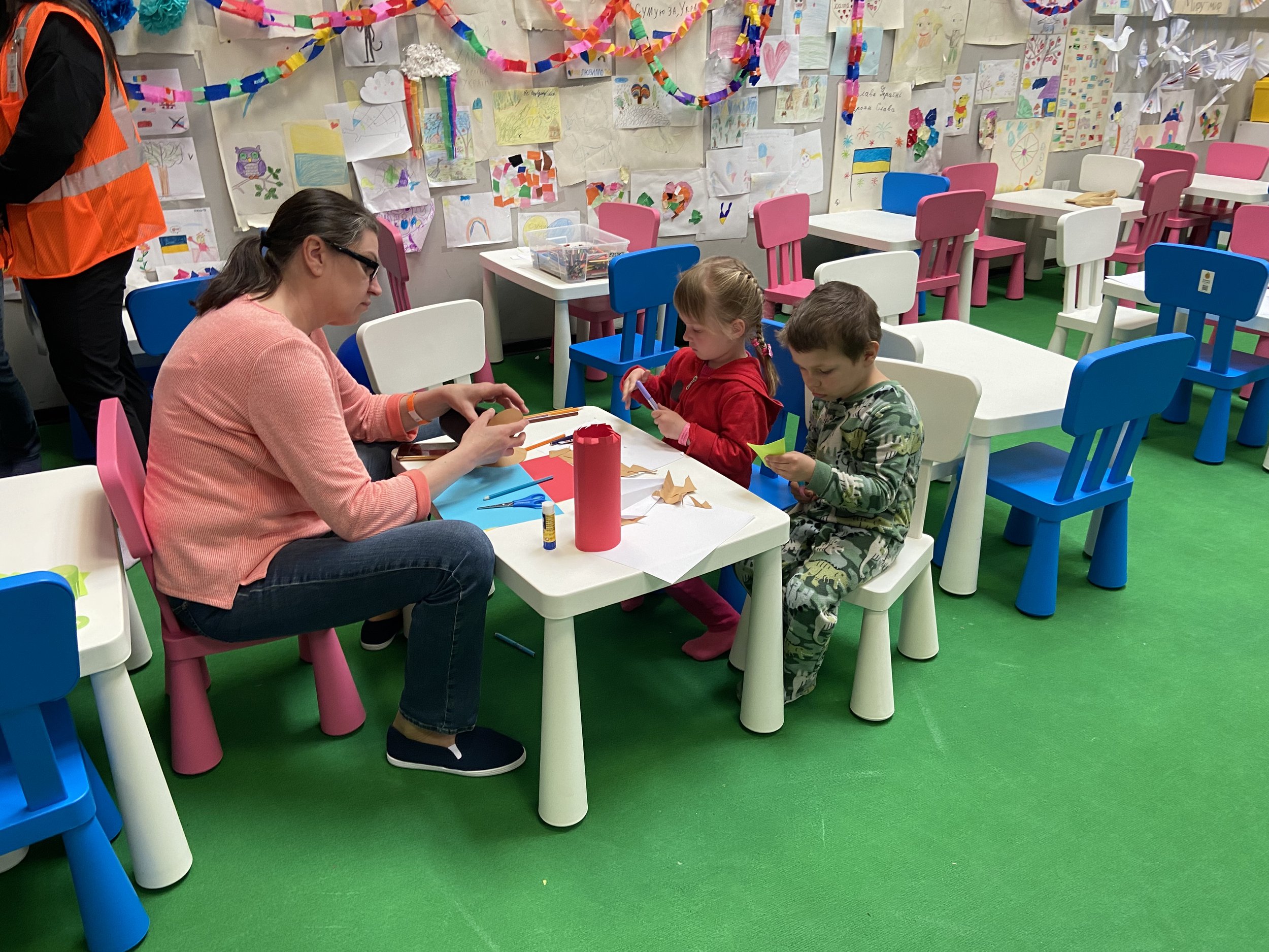 Kids making a craft with the room mom