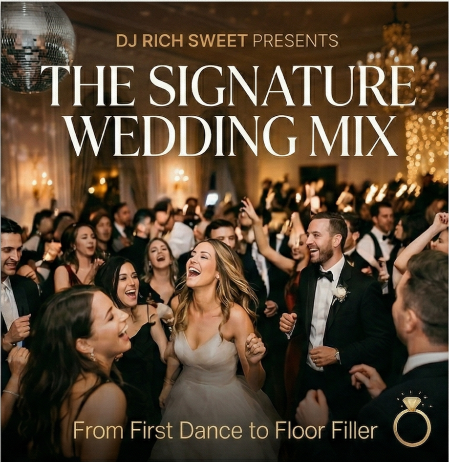 Wedding reception with dancing guests, a chandelier, and a disco ball.