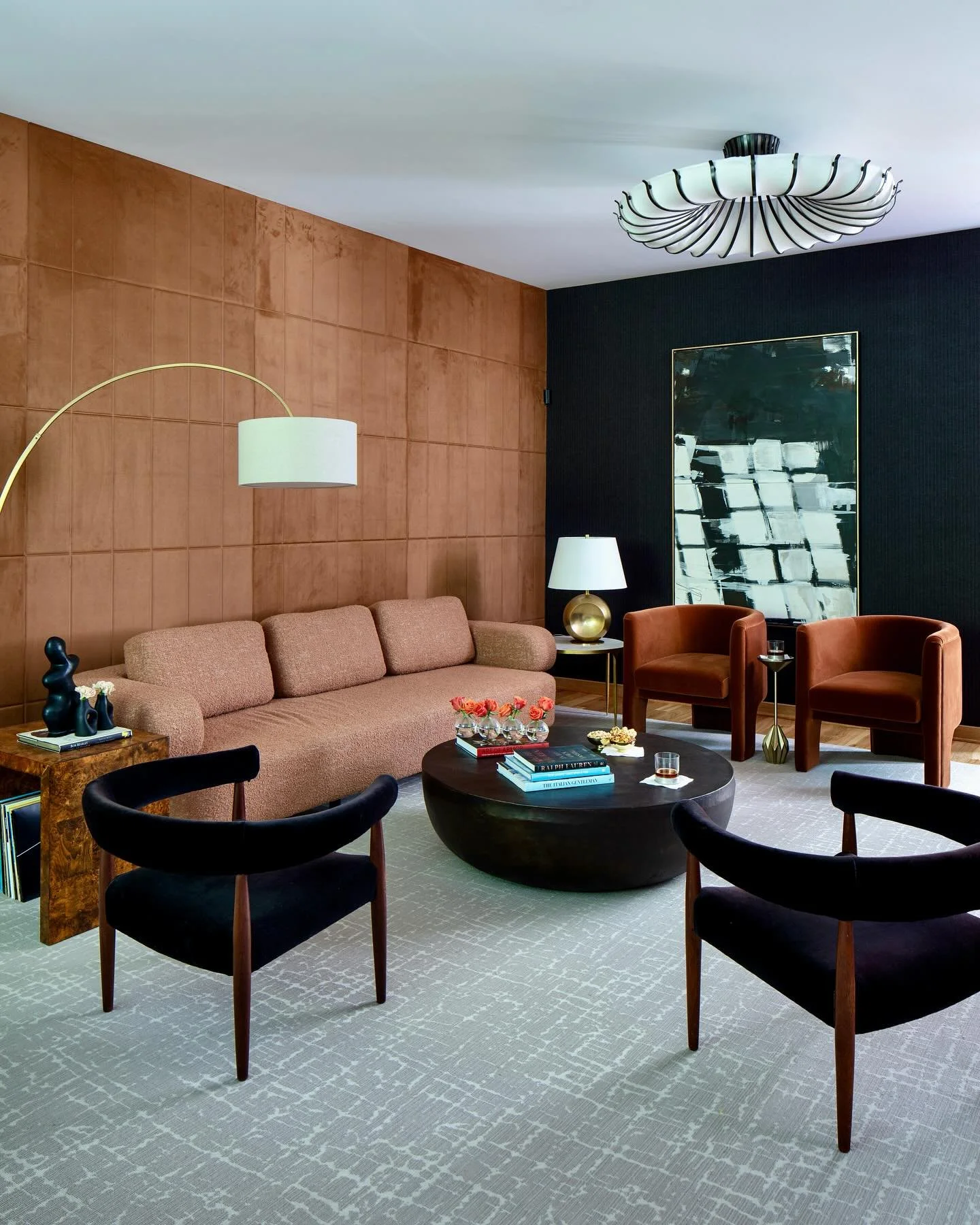 Bring on all the texture! These suede panels complimented by black flannel wallpaper transform this room into a sophisticated entertainment space.