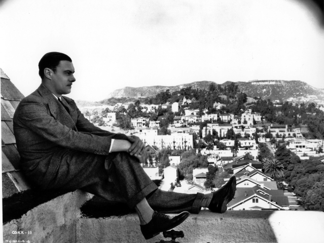 Colin Clive, the original Dr. Frankenstein, poses on the rooftop of Hollywood Tower. In the background you can see the Hollywood sign which originally read "Hollywoodland."
