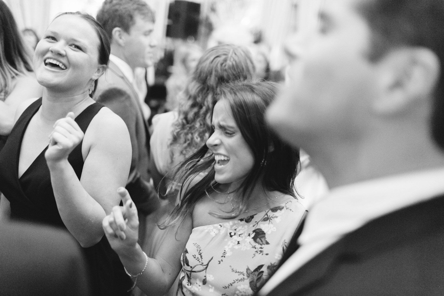 People at a celebration dancing and enjoying themselves in a lively environment.