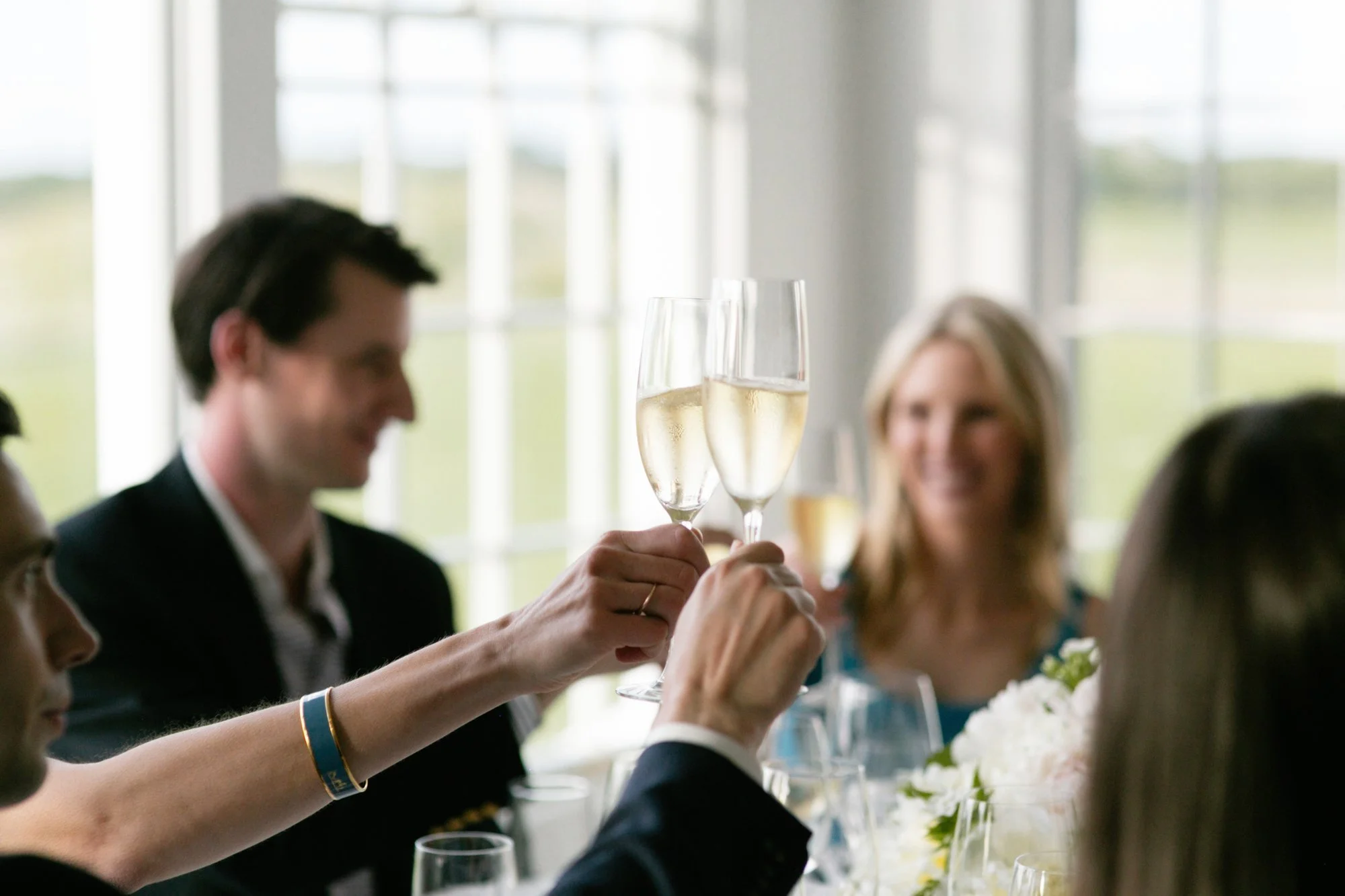 People raising champagne glasses in toast at a celebration or gathering
