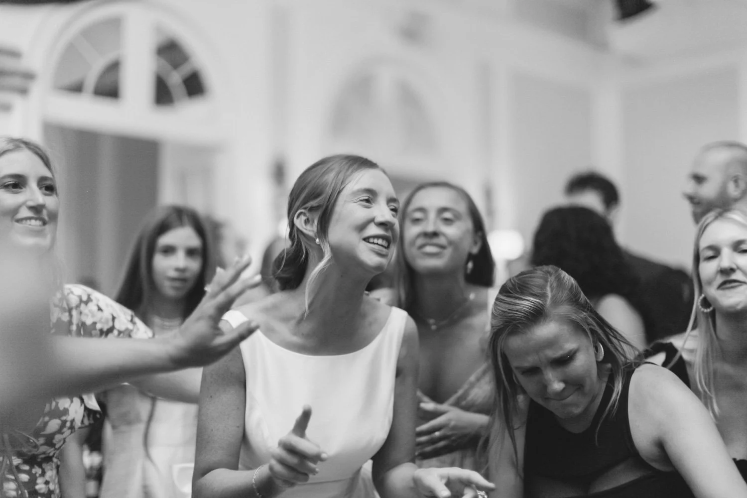 Group of women at a social gathering, smiling and enjoying themselves.