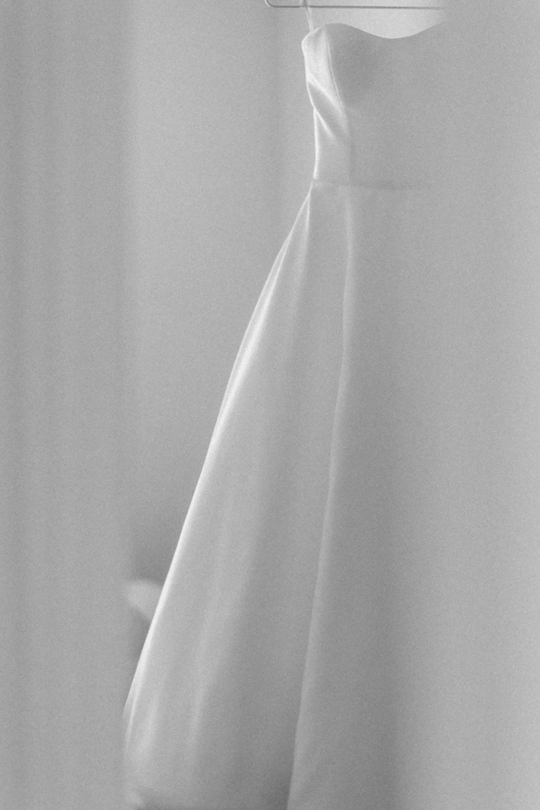Close-up of a crumpled, semi-transparent white or light-colored paper or fabric material, with soft lighting and shadows.
