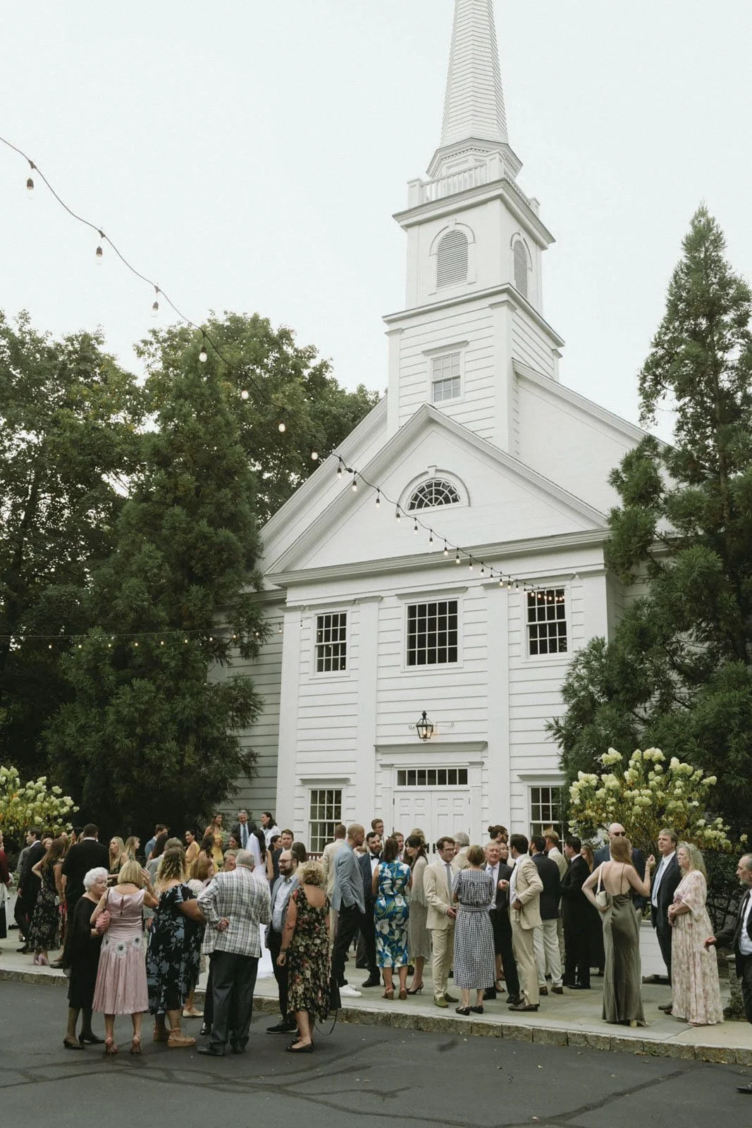 A large crowd of people gathered outside Stanwich Church in Greenwich, CT.  