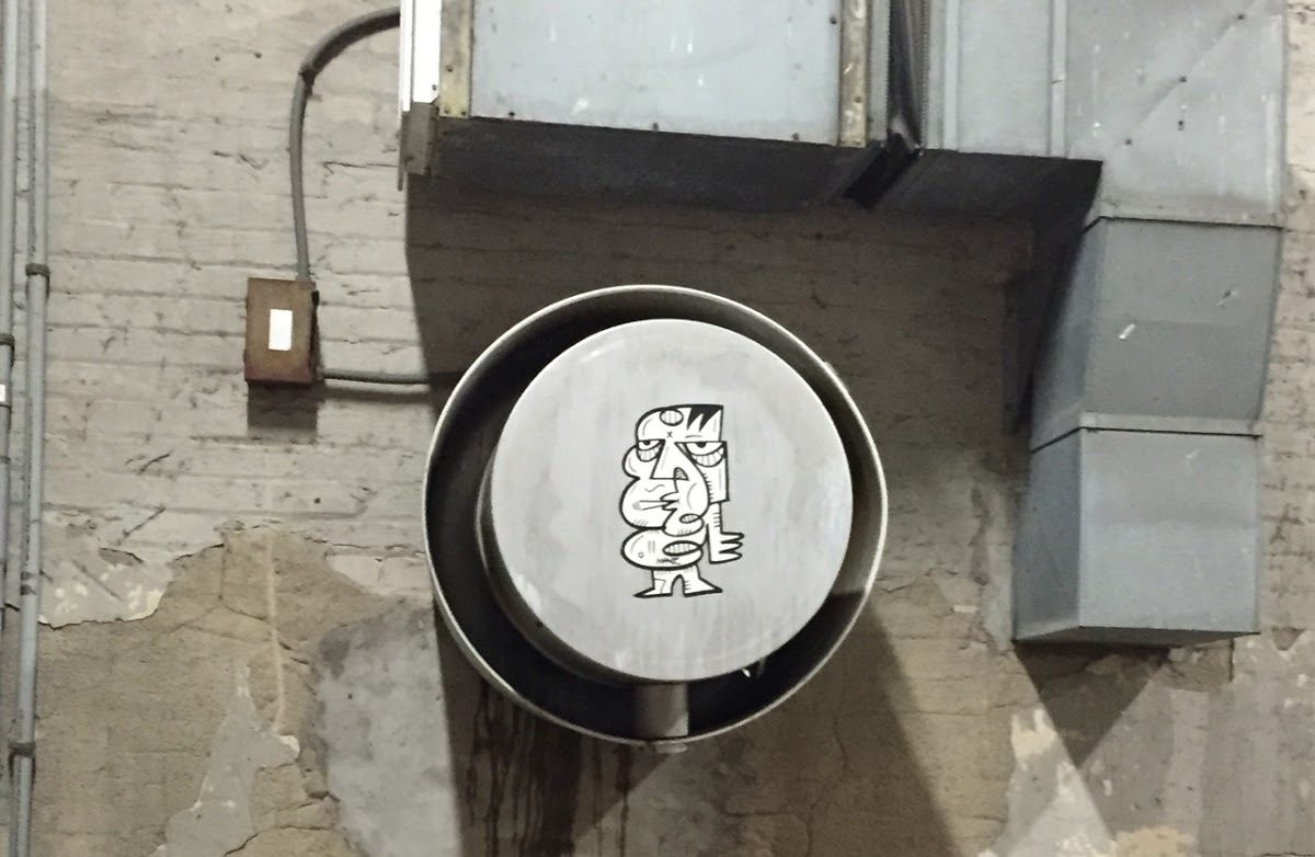 One of Matioc's wheat-pasted stickers in the wild. Photo courtesy of the artist.