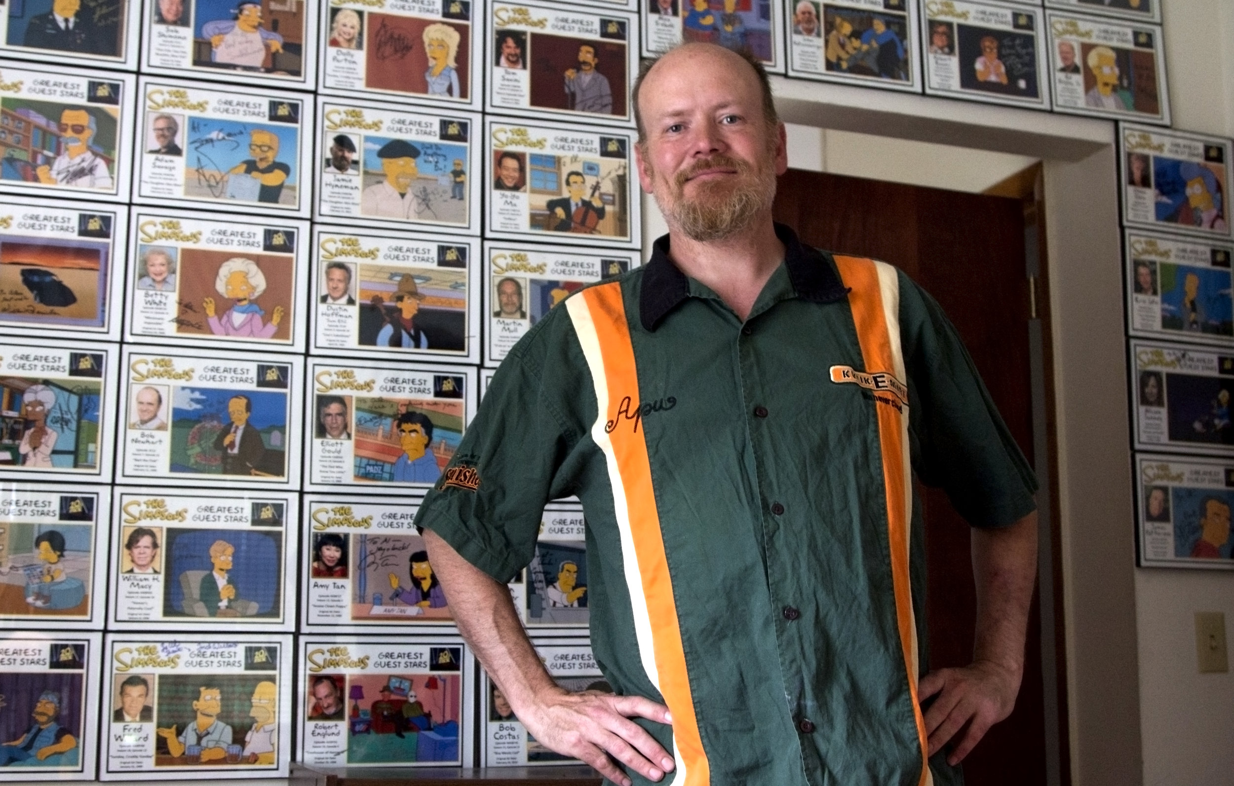 Al Hart at home with the autographs he's collected from "Simpsons" guest stars so far. Photo by Alan Talaga.