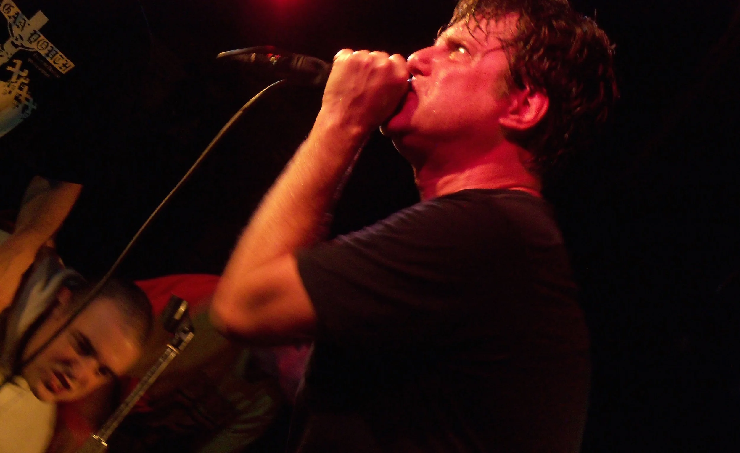 Negative Approach's John Brannon performing in 2009. Photo via T he All-Nite Images on Flickr.