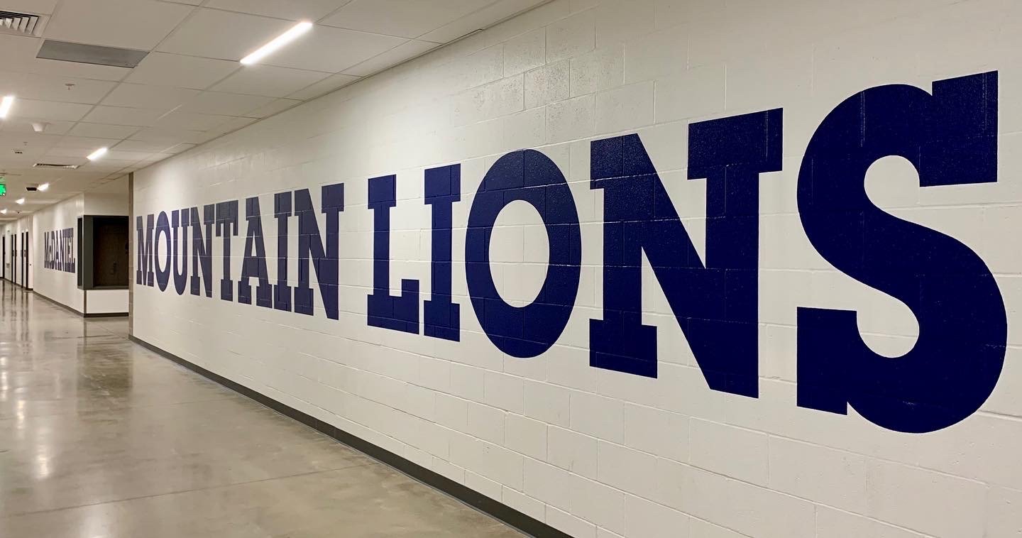 Hand-cut (no tape) 4'high lettering on cinderblock walls throughout McDaniel High School, Portland OR
